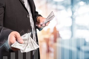 Businessman with money in hand, US dollar (USD) bills - investment, success and profitable business concepts