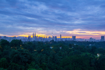 Majestic sunrise over KL Tower and surrounded buildings in downtown Kuala Lumpur, Malaysia.	