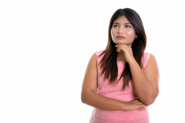 Fototapeta premium Studio shot of young fat Persian teenage girl thinking isolated 