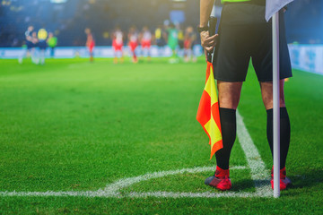 Lineman assistant referee at the corner of a soccer field. - obrazy, fototapety, plakaty