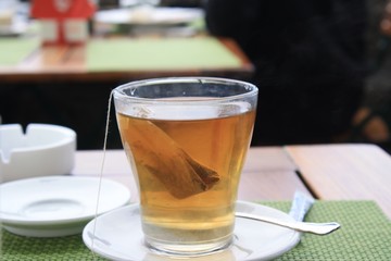 Tea in transparent glass cup with tea bag