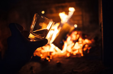 Whiskey glass with bonfire background