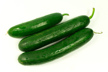 three big green cucumbers on a white background