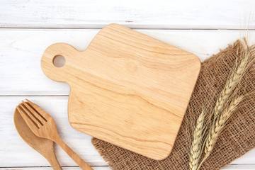  chopping board and tablecloth with wooden fork and spoon on white table , recipes food  for healthy habits shot note background concept