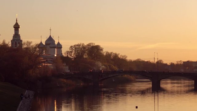 Evening promenade .bridge over the river overlooking the silhouette of the Church