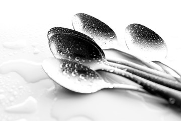 Spoon background / A spoon is a utensil consisting of a small shallow bowl oval or round, at the end of a handle