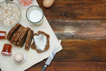 Healthy Breakfast. Fitness food. Eggs, Bread, Butter, Milk. Wooden Background. Flat Lay.