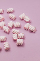 Flat lay of delicious sweet marshmallows on lilac background