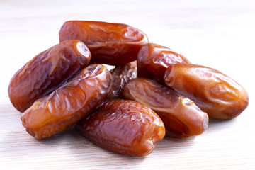 Date palm isolated on wooden background.