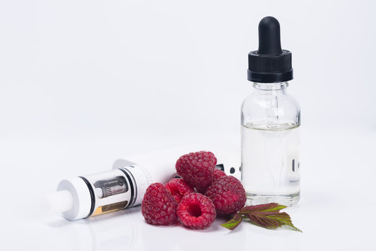 electronic cigarette and raspberry liquid in a bottle, concept on a white background