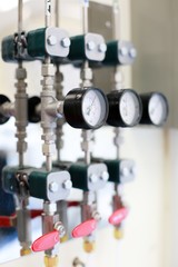 Closeup meter and valves on pipes in laboratory.