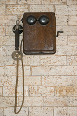 Fototapeta na wymiar Vintage telephone on brick wall.