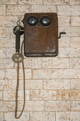 Vintage telephone on brick wall.