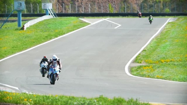Motorcyclists out of the turn and go on the track, the race, slow-motion