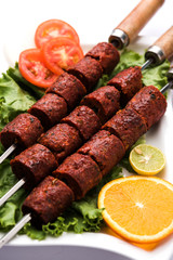 Indian Mutton Seekh Kabab served with green salad, selective focus