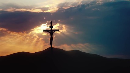 Calvary hill outside ancient Jerusalem where Jesus Christ was crucified. Dark sky and rays of light.