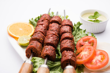Indian Mutton Seekh Kabab served with green salad, selective focus