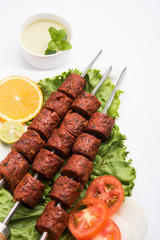Indian Mutton Seekh Kabab served with green salad, selective focus