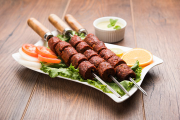 Indian Mutton Seekh Kabab served with green salad, selective focus