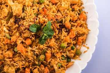 Indian Vegetable Pulav or Biryani made using Basmati Rice, served in terracotta bowl. selective focus
