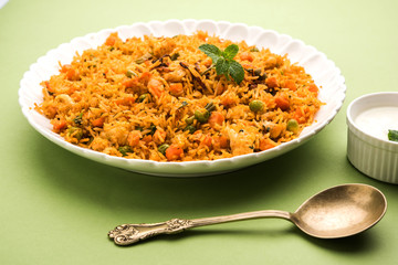 Indian Vegetable Pulav or Biryani made using Basmati Rice, served in terracotta bowl. selective focus