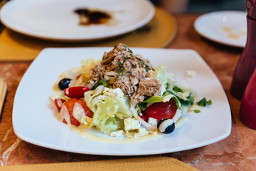 Italian tuna salad including cabbage, tomato, olive and tuna.