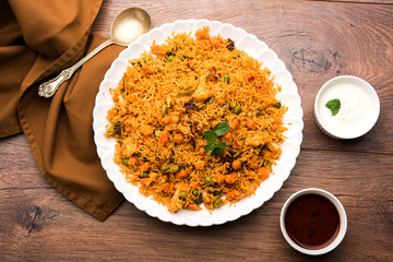 Indian Vegetable Pulav or Biryani made using Basmati Rice, served in terracotta bowl. selective...