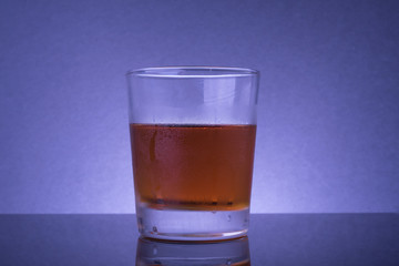 Alcoholic drink or liquor  in a transparent glass mug studio shot.