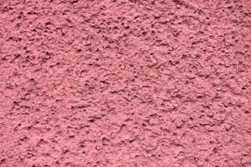 porous pink plaster structure on the wall