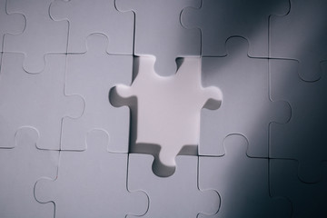 Empty and blank missing piece of jigsaw in white color background - business strategy and thinking solving problem concept.