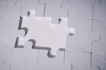 Empty and blank missing piece of jigsaw in white color background - business strategy and thinking solving problem concept.