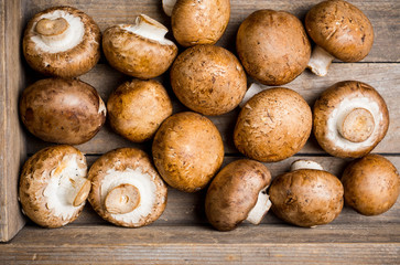 Fresh mushrooms on the rustic wooden background. Selective focus. Shallow depth of field.