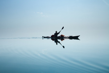 Fototapeta na wymiar A man in a sea kayak on Lake Baikal
