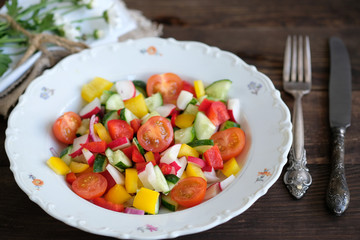  serving of salad from vegetables on old wooden table