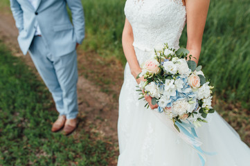 bride in a dress holding a wedding bouquet