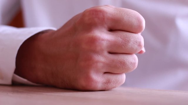 Boss fist beating on table