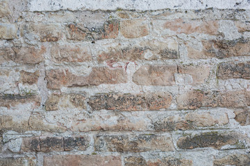 Fototapeta premium Old wall made of big stones and broken bricks. Vintage rough blocks surface background