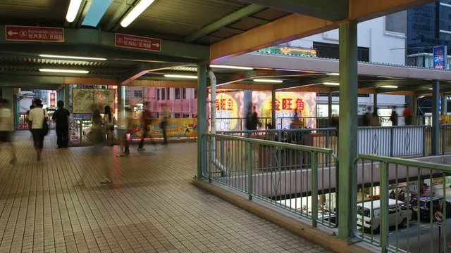 Elevated pedestrain walkway alongside a busy road in Mong Kok district, Kowloon, Hong Kong, China, T/lapse