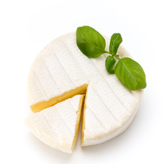 Piece of camembert cheese isolated on white background. From top view.