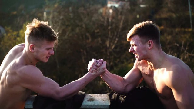 Arms wrestling, competition. Rivalry concept - close up of male arm wrestling. Leadership concept. Rivalry, vs, challenge, strength comparison. Two men arm wrestling.