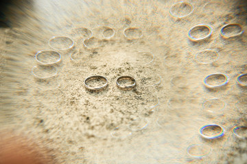 Visual illusion made of golden wedding rings