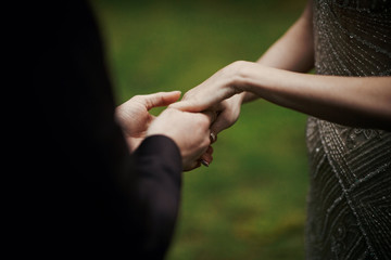 Bride and groom hold each other hands tender during the ceremony