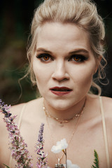 Portrait of blonde mysterious woman with yellow vampire eyes