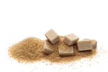 pile brown cane sugar cubes isolated on white background