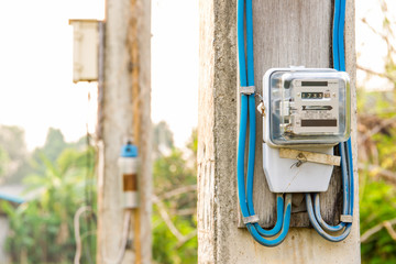Old electric meter on power pole close up for household use.