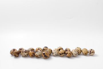 eggs quail spotted small on white background.