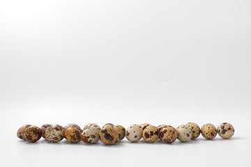 eggs quail spotted small on white background.