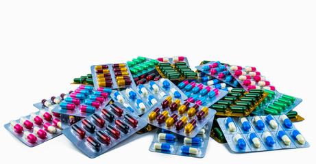 Colorful of antibiotic capsule pills isolated in blister pack isolated on white background with copy space. Antibiotic drug resistance. Pharmaceutical industry. Antimicrobial resistance concept.