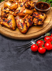 Grilled or oven roasted chicken wings glazed with barbecue sauce