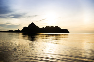 Landscape of a big mountain a long the sea during sun rise background.